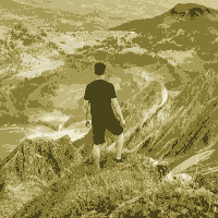 man in teashirt on mountain